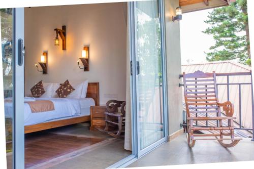 a bedroom with a bed and a sliding glass door at Grand Argyle Resort in Hatton