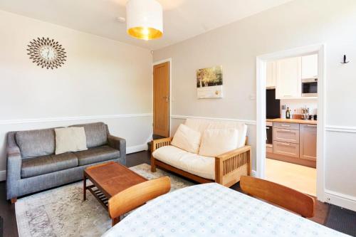 a living room with a couch and a chair at Leeds Home Away from Home with parking in Headingley