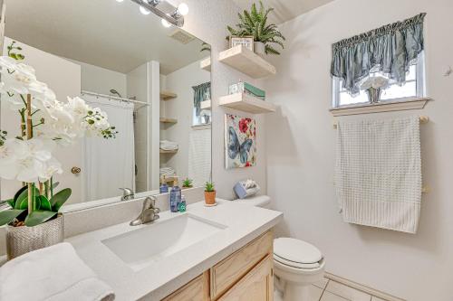 a bathroom with a sink and a toilet and a mirror at Pet-Friendly San Juan Home with Private Yard and Grill in San Juan
