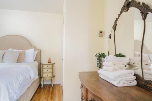 a bedroom with a bed and a mirror on a table at Sunrise and Bayview with Kayaks & Bikes in Meaford