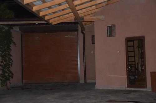 a garage with a door and a wooden ceiling at Happy Villa in Zovuni