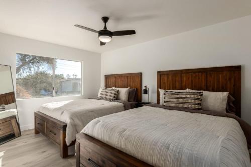 a bedroom with two beds and a ceiling fan at Modern Townhouse-Walk 2 OldTown-4 Heated Pools in Scottsdale