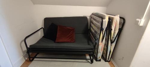 a chair with a pillow and a stack of newspapers at Semesterhus i Yngsjö in Yngsjö