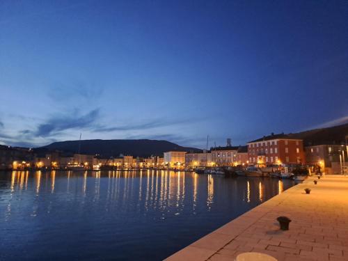 a view of a harbor at night at Atraktivna kuća sa saunom i grijanim jacuzzijem in Cres