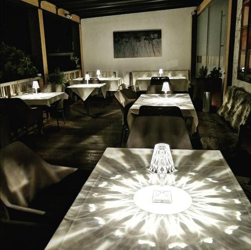 a restaurant with tables and chairs in a room at Triad Wiener Alpen Bett DZ in Bad Schönau