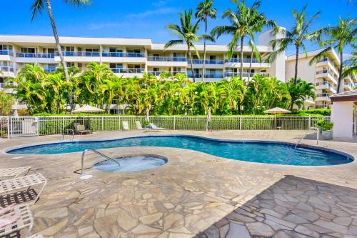 a swimming pool in front of a building at Maui Banyan Vacation Club in Wailea