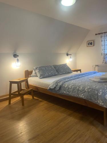 a bedroom with two beds and a table and lights at Pension Soutěsky in Hřensko