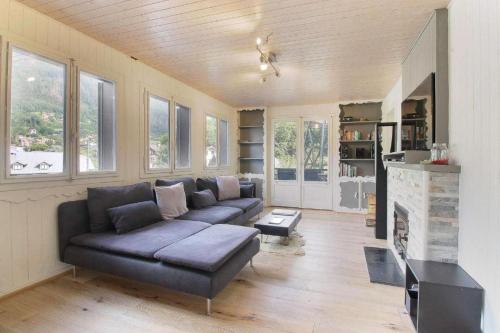 un salon avec un canapé et une cheminée dans l'établissement Chalet La Cordée, 160m2, 4 chambres, sauna, à Saint-Gervais-les-Bains