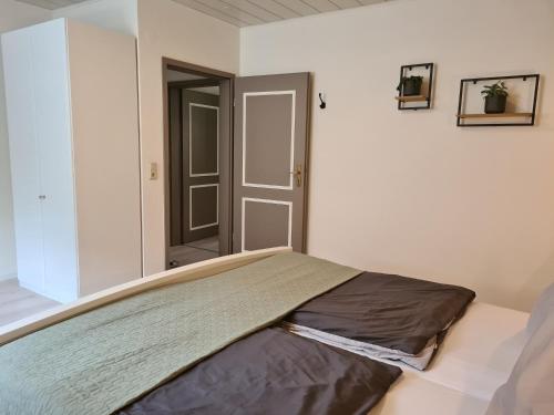 a bed in a room with a door in it at FeWo Alt Beilstein in Beilstein