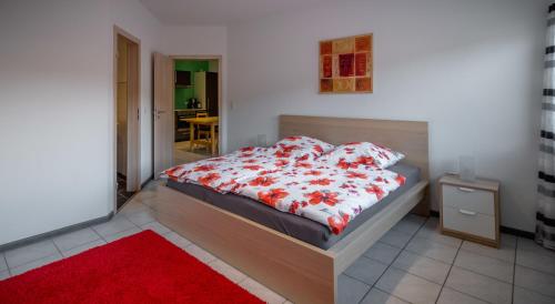 a bedroom with a bed with a red and white blanket at Moseltraum in Bruttig-Fankel