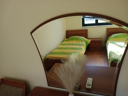 a room with two beds and a table with a mirror at Apartman Olja in Radovići
