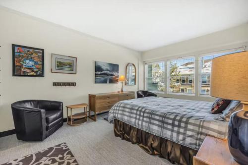 a bedroom with a bed and a desk and a chair at Edelweiss Haus by All Seasons Resort Lodging in Park City