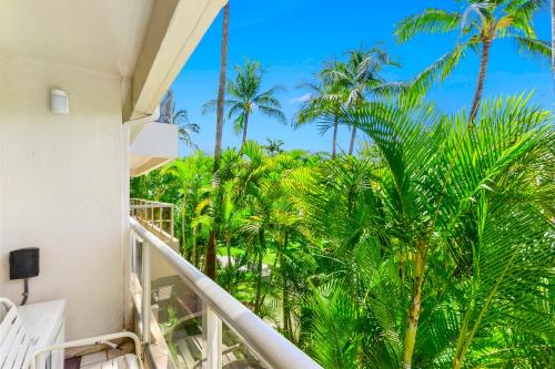 a view from the balcony of a resort with palm trees at Maui Banyan Vacation Club in Wailea