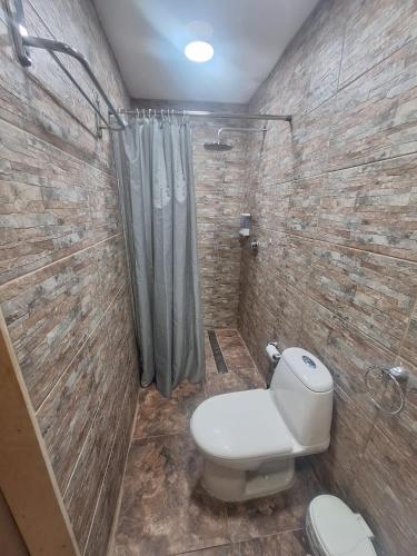 a bathroom with a toilet and a shower at Kas di Nort in Kralendijk