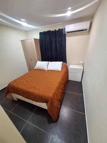 a bedroom with a bed with a brown blanket at Kas di Nort in Kralendijk