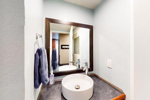 a bathroom with a white sink and a mirror at The Adventure Pad, Unit 1 in Branson