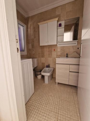 a bathroom with a sink and a toilet and a sink at Vila Lavanda in Playa de las Americas
