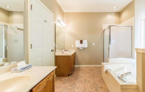 a bathroom with two sinks and a tub and a shower at Branson Condo at Stonebridge Golf Resort with Pool and Wi-Fi near Silver Dollar City and 76 in Reeds Spring