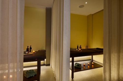 a room with two tables with bottles and candles at Blues Suites Medellín in Medellín