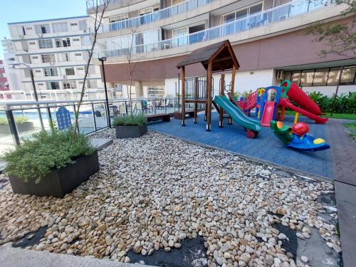 a playground with a slide and a swing set at Book Santos - Unlimited 1709 - Apartamento Vista Mar in Santos