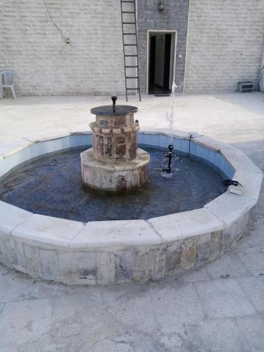 a fountain in a courtyard in front of a building at شقة فاخرة مع مطل luxerious with nice view in Amman