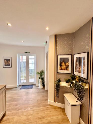 a living room with a hardwood floor and a hallway at Newly renovated Private Self contained Room in Selly Oak Birmingham with bathroom shared between two rooms R1 in Birmingham
