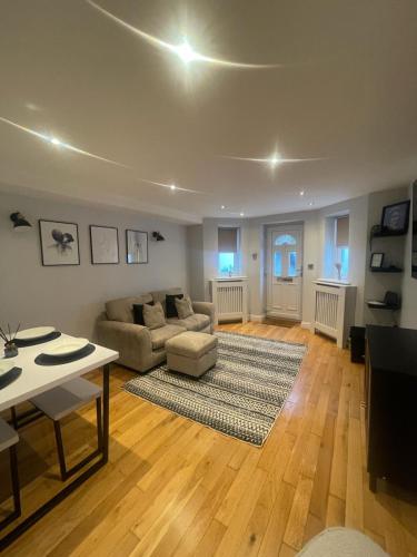 a living room with a couch and a table at Central Windsor in Windsor