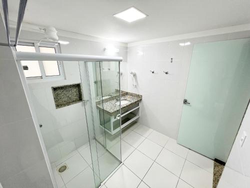 a bathroom with a shower and a glass door at Piazza Diroma in Caldas Novas