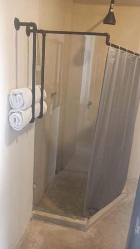 a shower with two rolls of towels in a bathroom at Xùva in Mérida