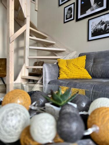 a living room with a couch and a bunch of coconuts at Casa Kashubia - Nowoczesny dom wakacyjny nad jeziorem - Cisza natura i komfort in Brzeźno Szlacheckie