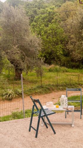 a picnic table and a bench in front of a fence at Drys Stone House in Miriokéfala