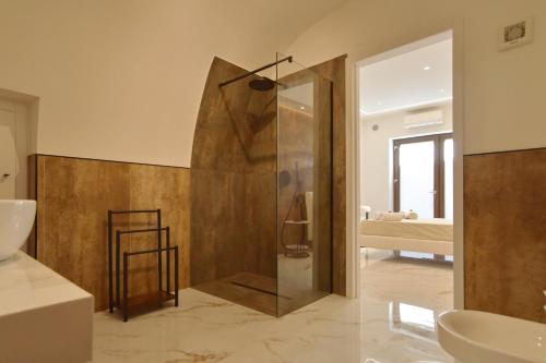 a bathroom with a shower and a sink at FLA' Suite Deluxe in Terrasini