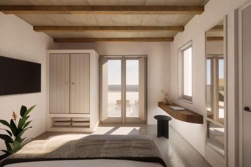 a bedroom with a bed and a large window at Seascape, Apartment 3 with sea view in Áno Meriá