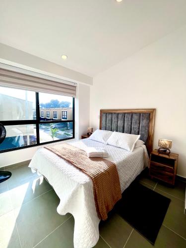 a bedroom with a large bed and a large window at Casa Turística en el Quindío in La Tebaida