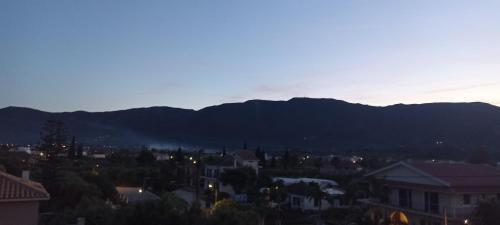 a view of a city with mountains in the background at Hector's Studios in Alikanas