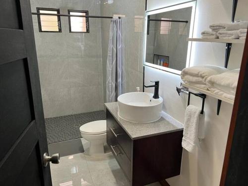 a bathroom with a sink and a toilet and a shower at Chabayali House in San Juan del Sur