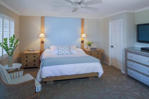 a bedroom with a bed and a flat screen tv at Scripps Inn in San Diego
