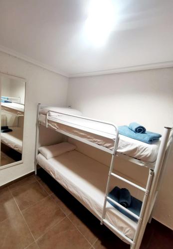a room with two bunk beds and a mirror at Ave Maria Toledo in Toledo