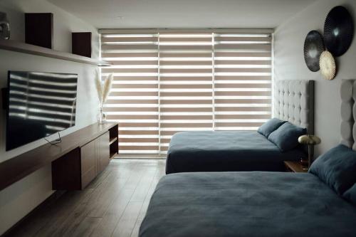 Katil atau katil-katil dalam bilik di Lujoso apartamento en el Norte