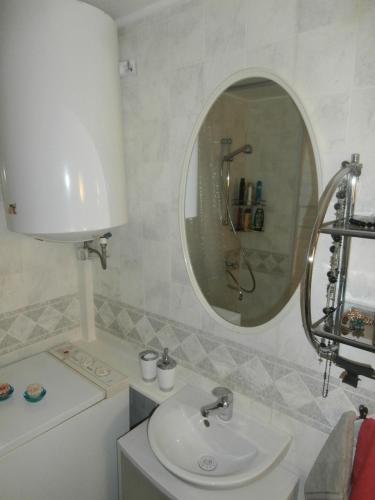 a bathroom with a sink and a mirror at Private Apartment For You in Tartu