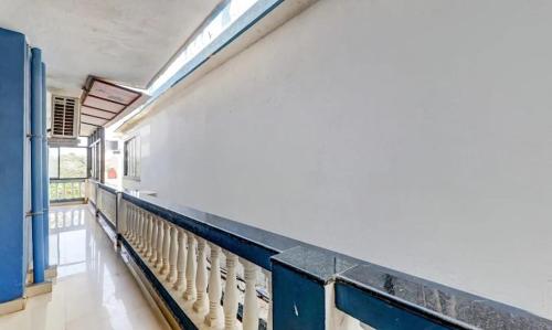 a hallway of a building with a blue railing at Hotel Ocean Face, BAGA in Baga