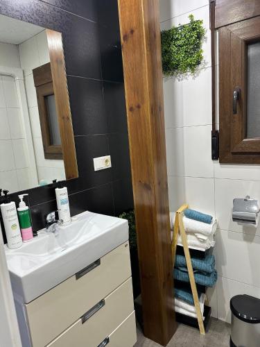 a bathroom with a sink and a mirror at La Buhardilla del Cielo in Villahermosa del Río