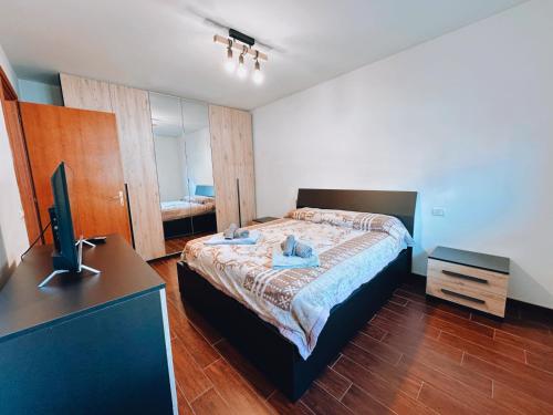 a bedroom with a bed and a desk and a television at Finestra su Villalago in Villalago
