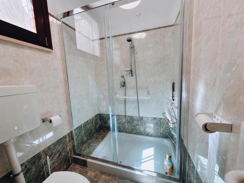 a bathroom with a shower and a tub with a toilet at Finestra su Villalago in Villalago