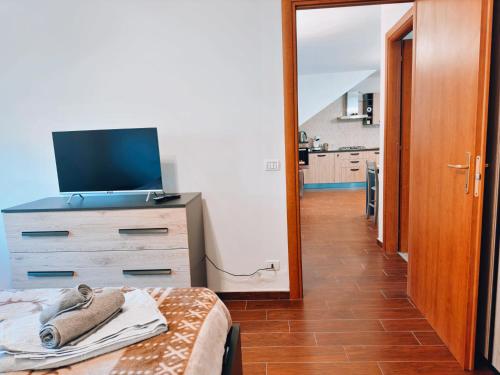 a bedroom with a bed and a dresser with a television at Finestra su Villalago in Villalago