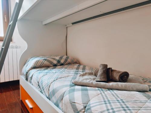a bedroom with a bed with towels on it at Finestra su Villalago in Villalago