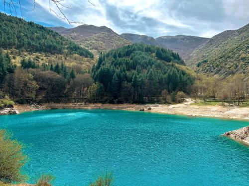 a blue lake in the middle of a mountain at Finestra su Villalago in Villalago