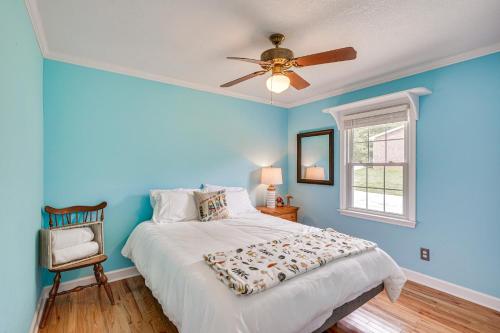 ein blaues Schlafzimmer mit einem Bett und einem Deckenventilator in der Unterkunft Waterfront Lake Gaston Home with Private Dock! in Littleton