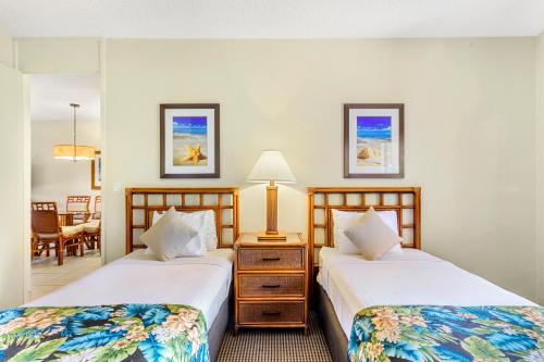 two beds sitting next to each other in a room at Hono Koa Vacation Club in Lahaina