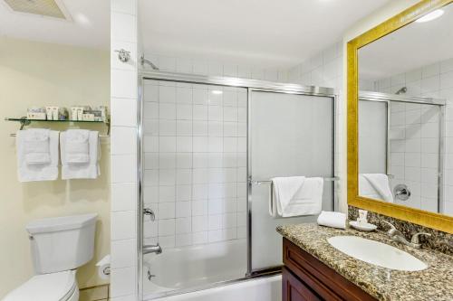 a bathroom with a shower and a toilet and a sink at Hono Koa Vacation Club in Lahaina